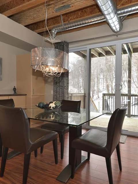 a glass kitchen table surrounded by four dining room chairs