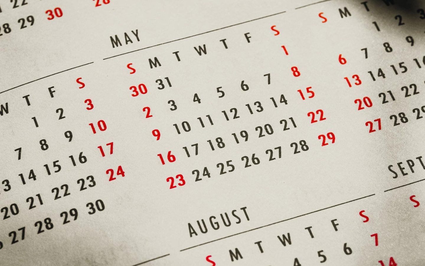 partial view of a calender with the name may and august visible