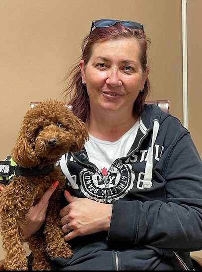 woman holding a brown puppy