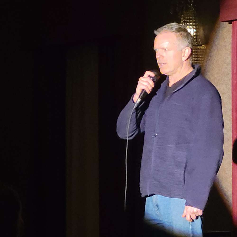 a man standing in front of a microphone